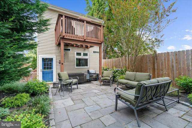a backyard of a house with table and chairs