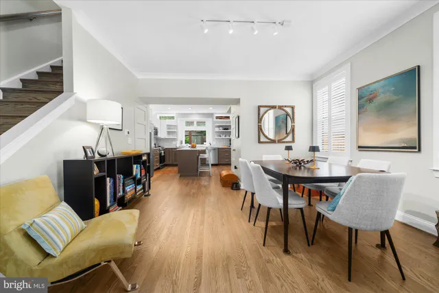 a living room with furniture a rug and wooden floor