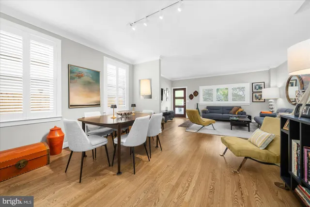 a living room with furniture a wooden floor and a window