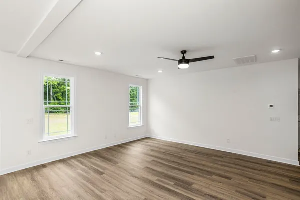 a view of kitchen with stainless steel appliances refrigerator oven stove microwave and cabinets
