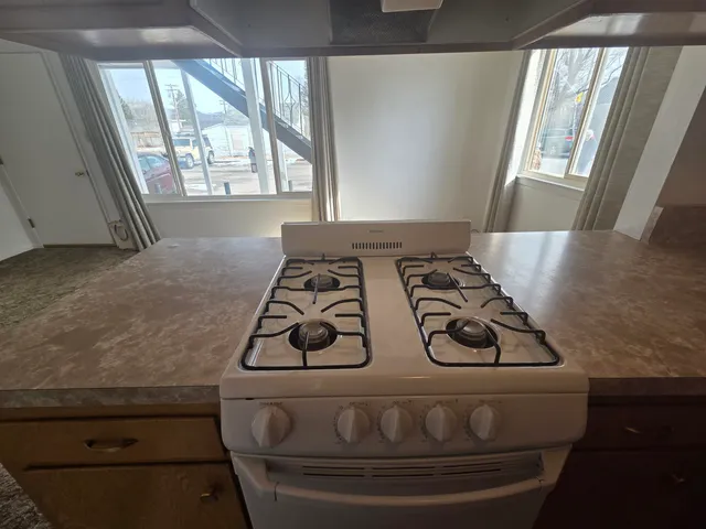 a kitchen with a stove and a refrigerator