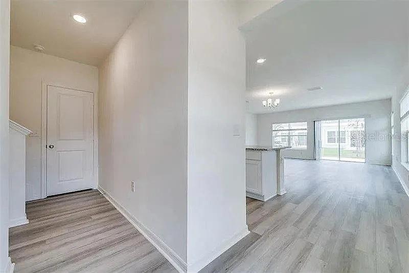 2302 Carrabelle Way Sanford, FL 32771 - Photo 14 of 24 a view of empty room with wooden floor and fan