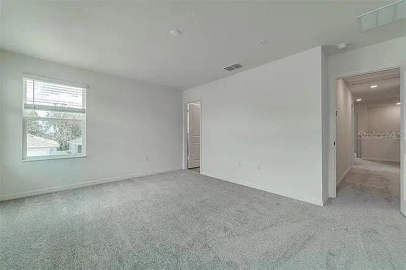 2302 Carrabelle Way Sanford, FL 32771 - Photo 17 of 24 an empty room with windows and closet