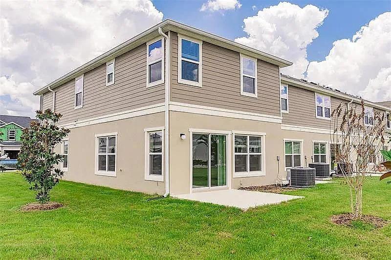 2302 Carrabelle Way Sanford, FL 32771 - Photo 2 of 24 a front view of a house with a yard