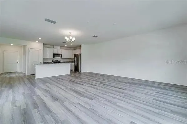 a view of kitchen with wooden floor and a sink