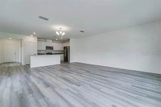 a view of kitchen with wooden floor and a sink