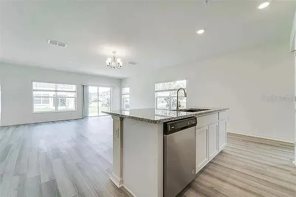 a kitchen with stainless steel appliances granite countertop a stove and cabinets