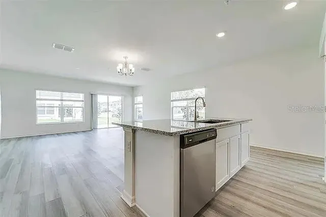 a kitchen with stainless steel appliances granite countertop a stove and cabinets