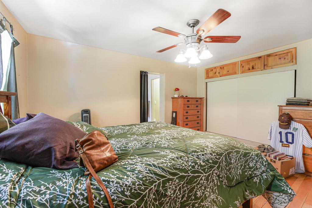 29012 Oak Lane Pine Valley, CA 91962 - Photo 26 of 38 a bedroom with a bed and a chandelier