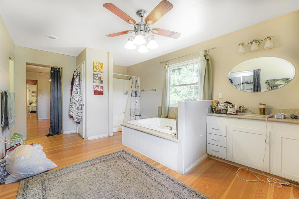 29012 Oak Lane Pine Valley, CA 91962 - Photo 28 of 38 a spacious bedroom with a bed a window and a mirror