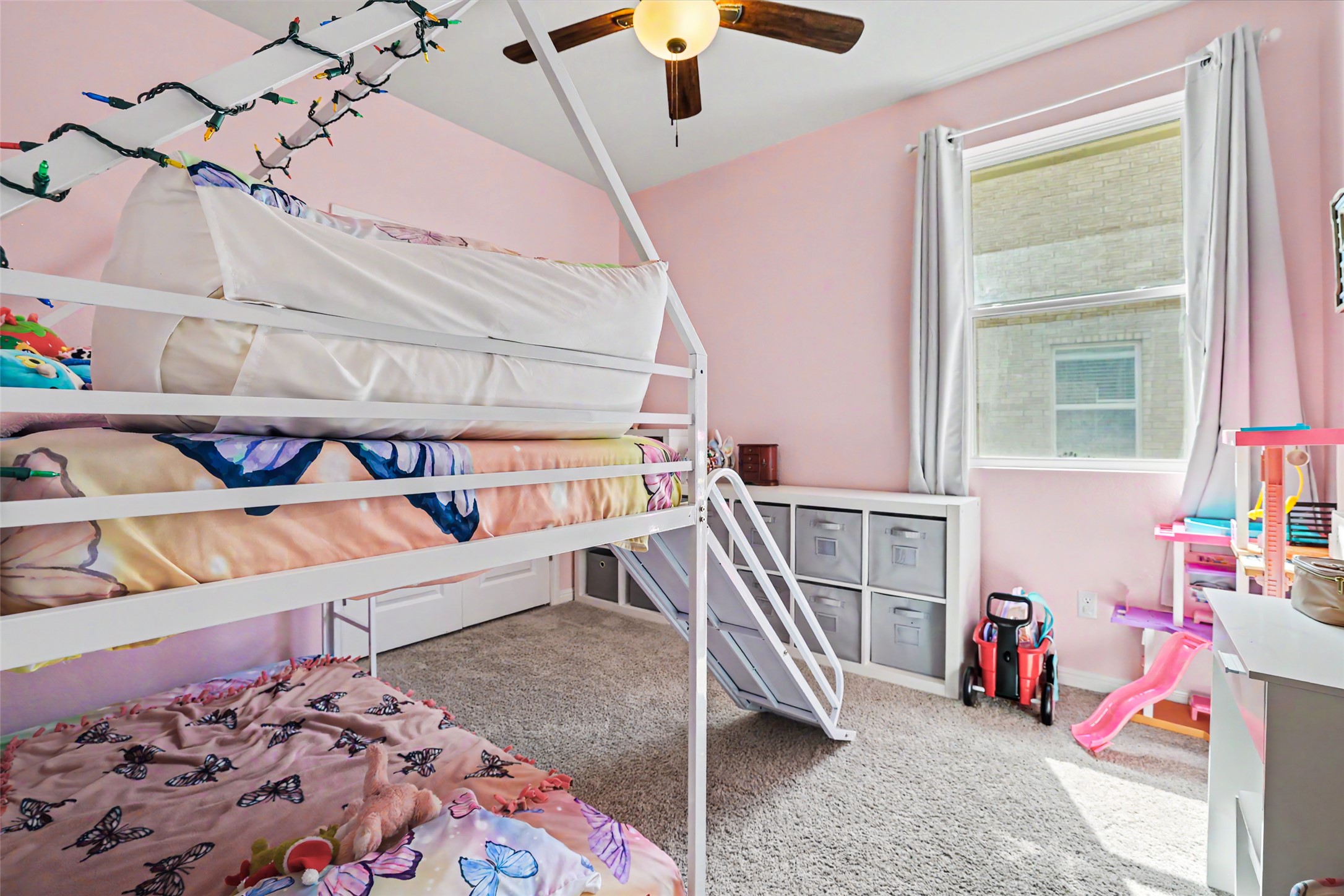 112 Rocking R Court Georgetown, TX 78633 - Photo 26 of 40 A well-lit bedroom with soft carpeting and ample storage beneath a window, offering a cheerful atmosphere.