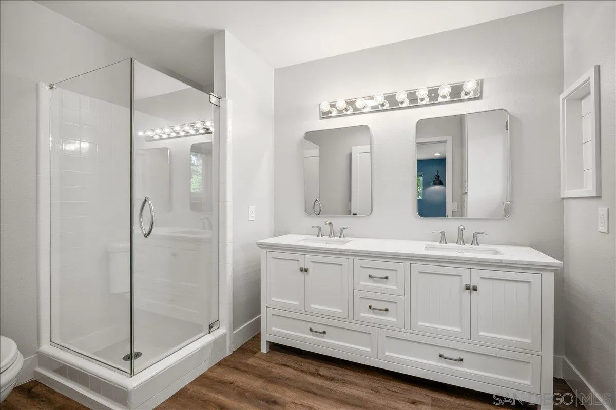20809 Viento Valle Escondido, CA 92025 - Photo 12 of 23 a bathroom with a double vanity sink a mirror and a shower