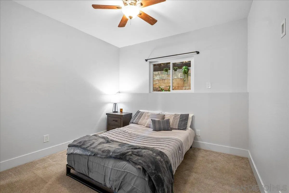 20809 Viento Valle Escondido, CA 92025 - Photo 16 of 23 a bedroom with a bed and a chandelier