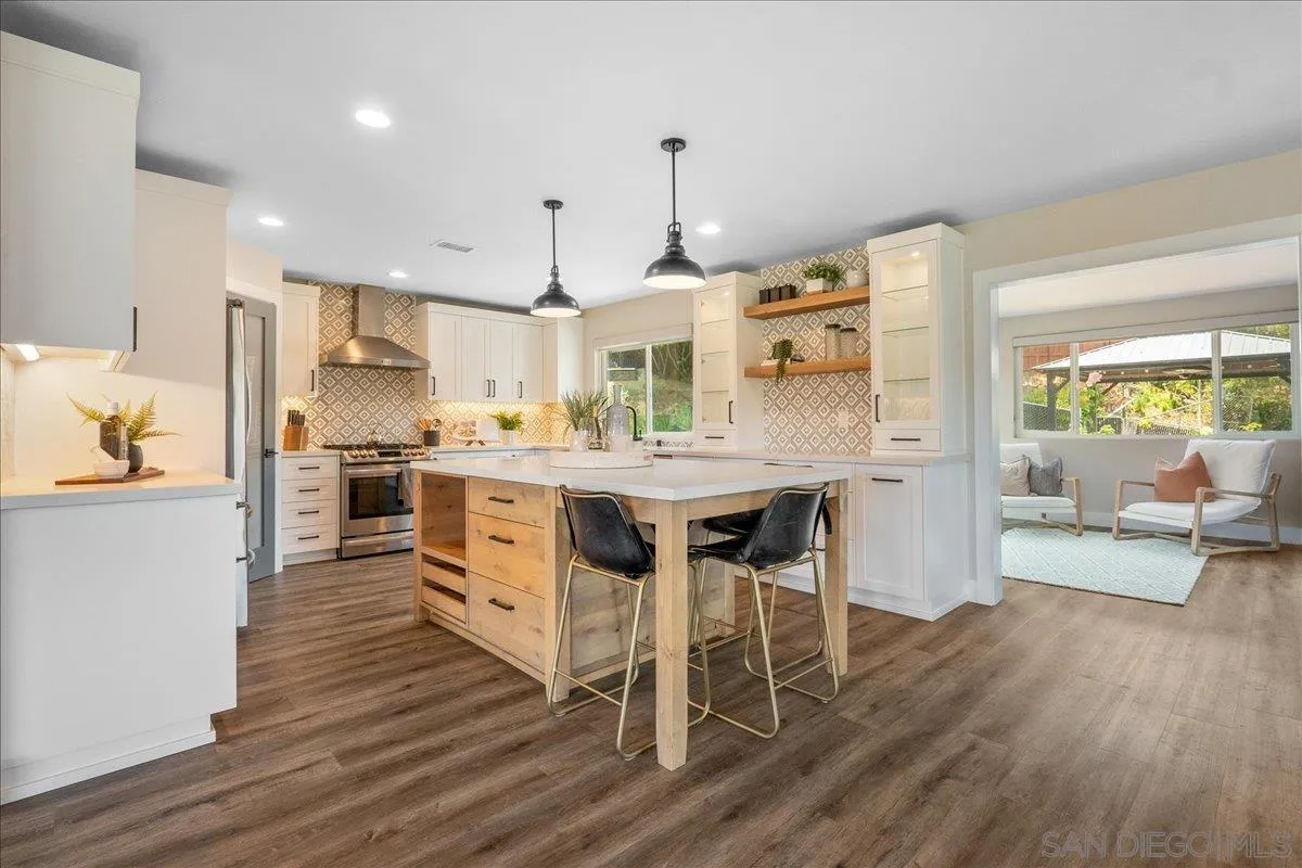 20809 Viento Valle Escondido, CA 92025 - Photo 4 of 23 a large kitchen with a table and chairs in it