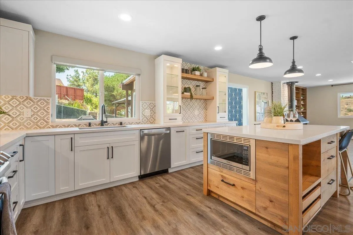 20809 Viento Valle Escondido, CA 92025 - Photo 6 of 23 a kitchen with stainless steel appliances granite countertop a stove and a sink