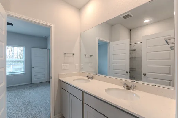 a bathroom with a double vanity sink mirror and double