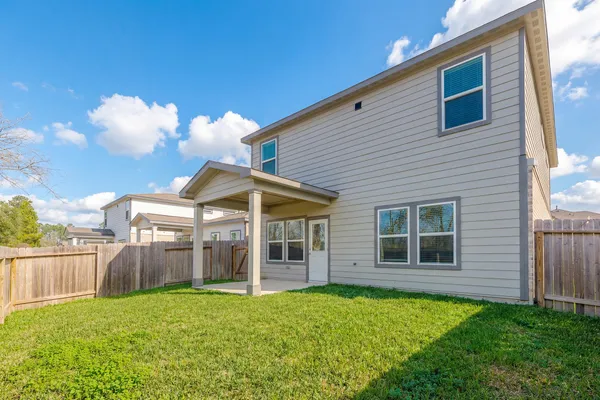 a view of a house with backyard and porch