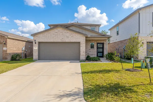a view of yellow house with palm trees