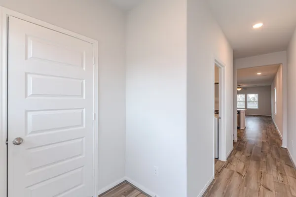 a view of a hallway with wooden floor