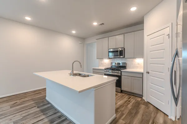 a kitchen with a sink stainless steel appliances and cabinets