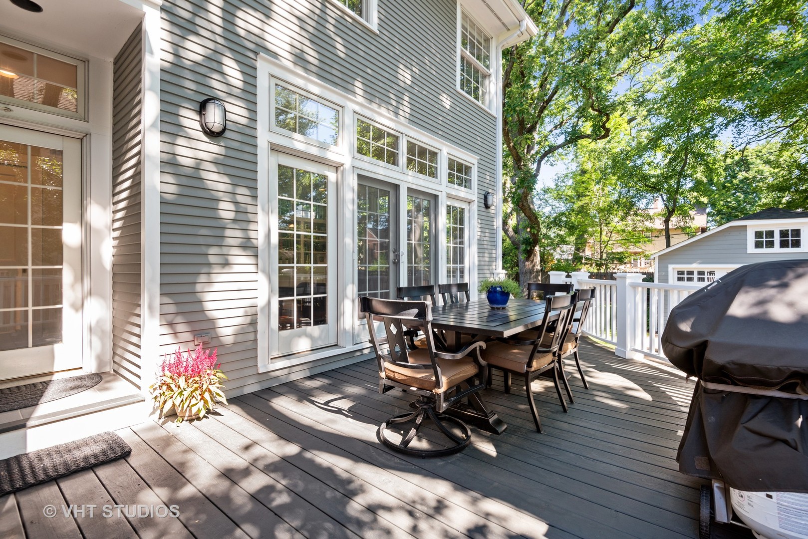 561 Elder Lane Winnetka, IL 60093 - Photo 19 of 26 a view of a patio with table and chairs and wooden floor