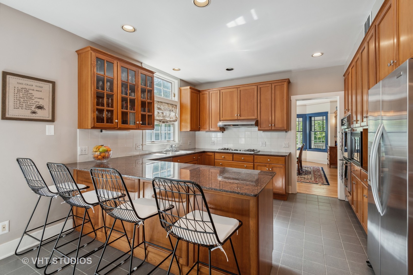 561 Elder Lane Winnetka, IL 60093 - Photo 4 of 26 a dining hall with stainless steel appliances granite countertop a table and chairs in it