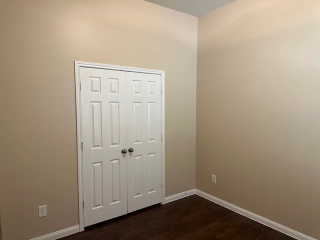 an empty room with wooden floor