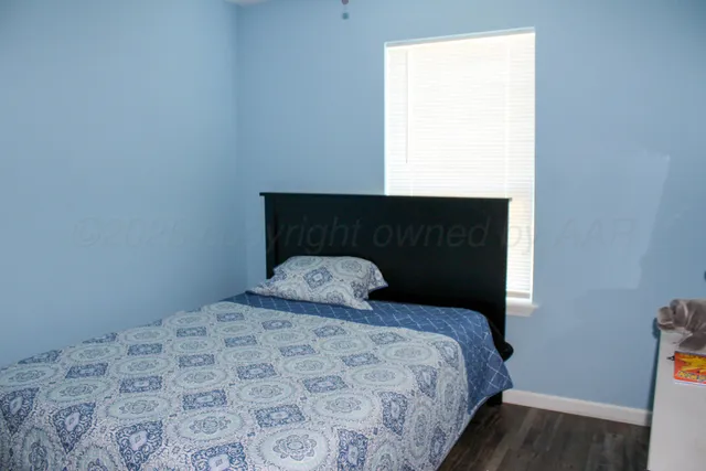 a bed sitting in a bedroom next to a window