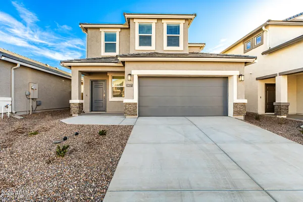 a front view of a house with a yard and garage