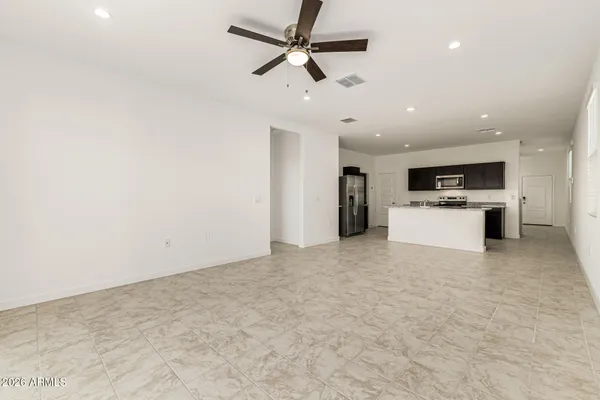 a view of kitchen with a sink stainless steel appliances and cabinets