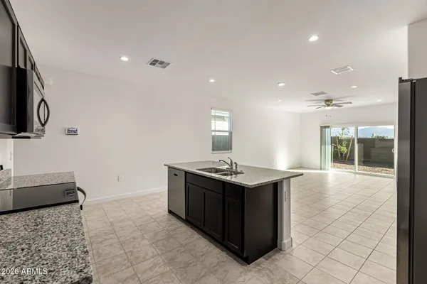 a kitchen with stainless steel appliances granite countertop a sink and a stove