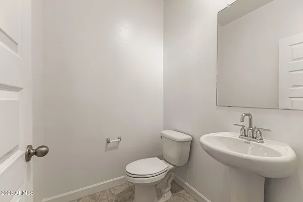 a bathroom with a sink toilet and a mirror