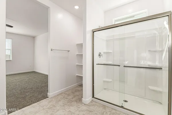 a bathroom with a glass shower door