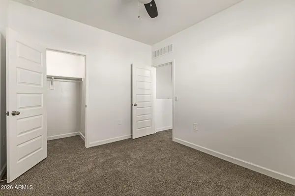 an empty room with closet and window
