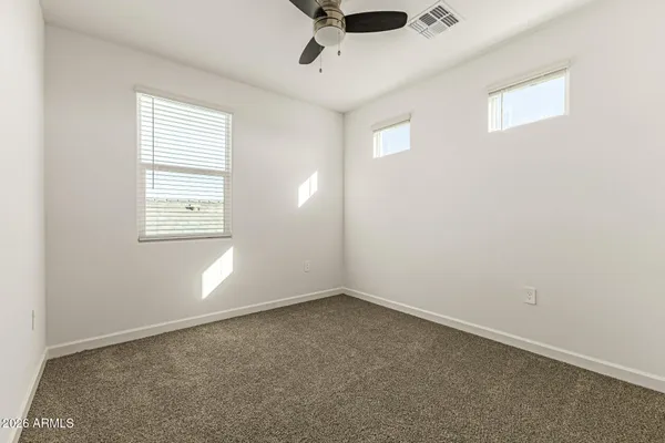 an empty room with a empty space and windows