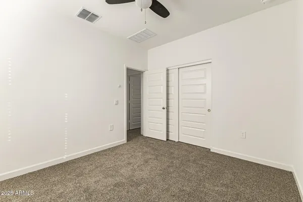 an empty room with closet area