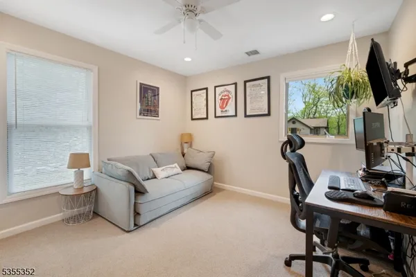 a living room with furniture a window and a flat screen tv