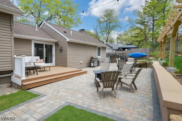 a view of a house with backyard and sitting area