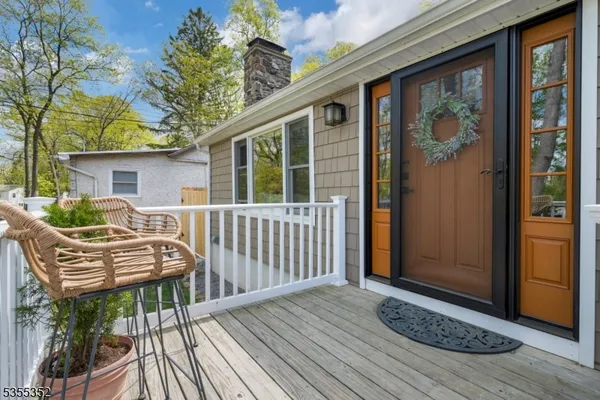 a view of a deck with furniture and window