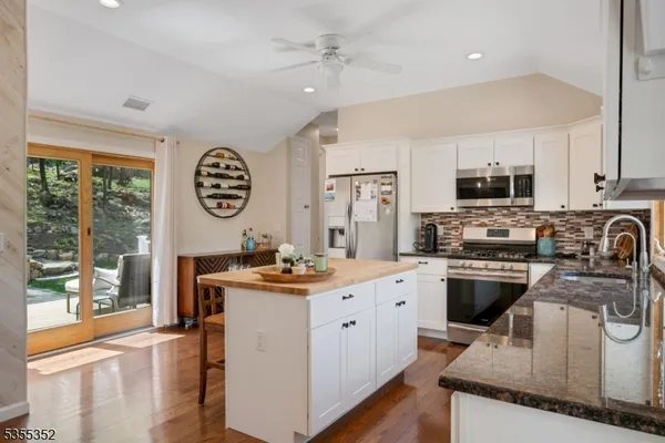 a kitchen with a stove a sink and a refrigerator