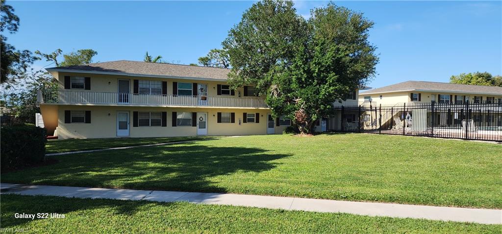 3325 Airport Road North, Unit J3 Naples, FL 34105 - Photo 1 of 13 a front view of a house with a garden