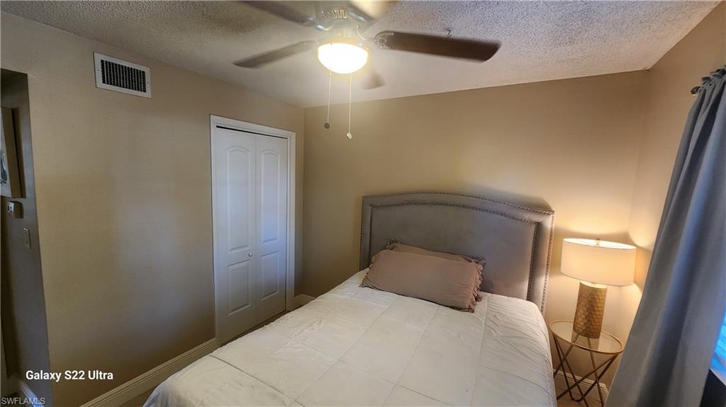 3325 Airport Road North, Unit J3 Naples, FL 34105 - Photo 12 of 13 a bedroom with a bed and a window