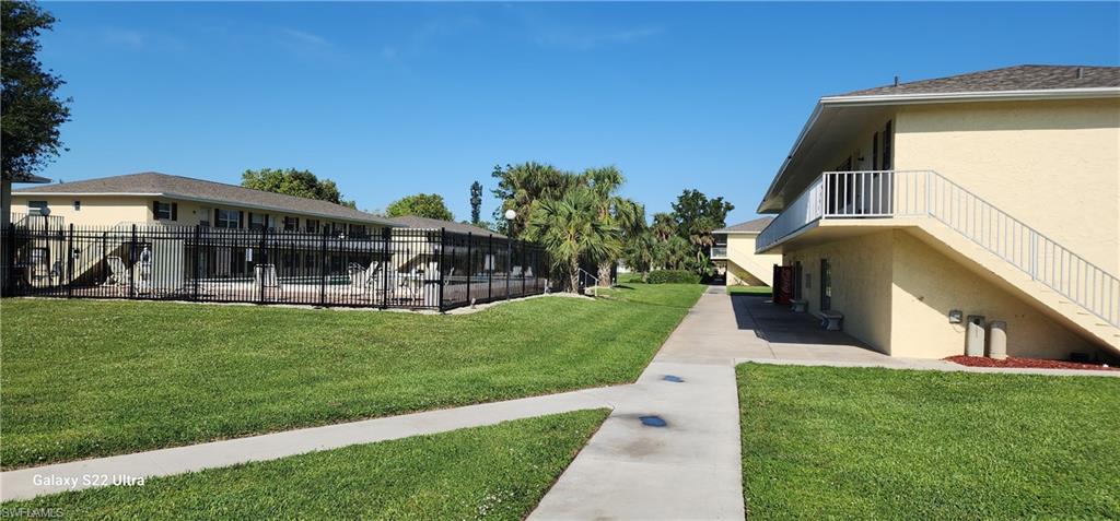 3325 Airport Road North, Unit J3 Naples, FL 34105 - Photo 3 of 13 a view of a house with a yard