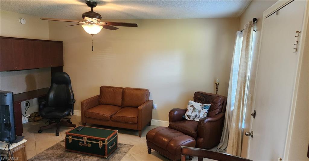 3325 Airport Road North, Unit J3 Naples, FL 34105 - Photo 5 of 13 a living room with furniture a flat screen tv and a window