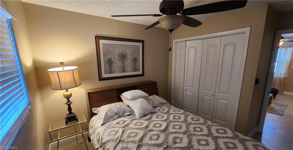 3325 Airport Road North, Unit J3 Naples, FL 34105 - Photo 7 of 13 a bedroom with a bed and a mirror on dresser