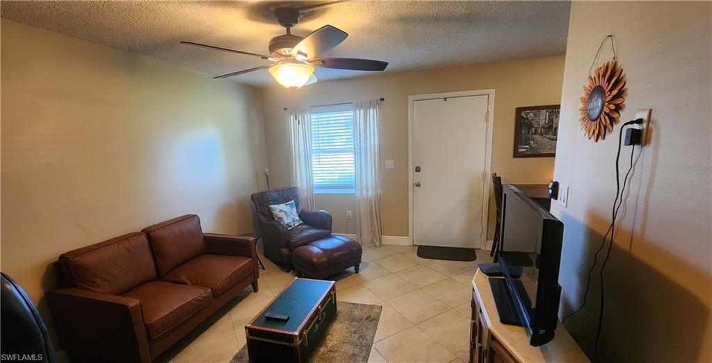 3325 Airport Road North, Unit J3 Naples, FL 34105 - Photo 8 of 13 a living room with furniture a ceiling fan and a rug
