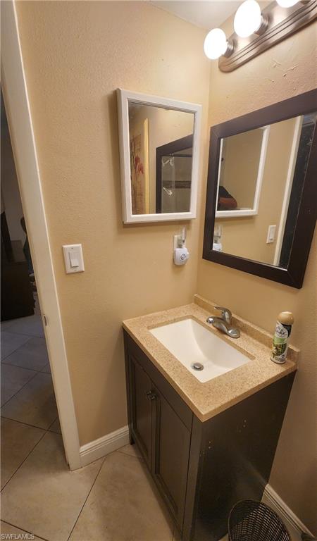 3325 Airport Road North, Unit J3 Naples, FL 34105 - Photo 10 of 13 a bathroom with a sink vanity and mirror