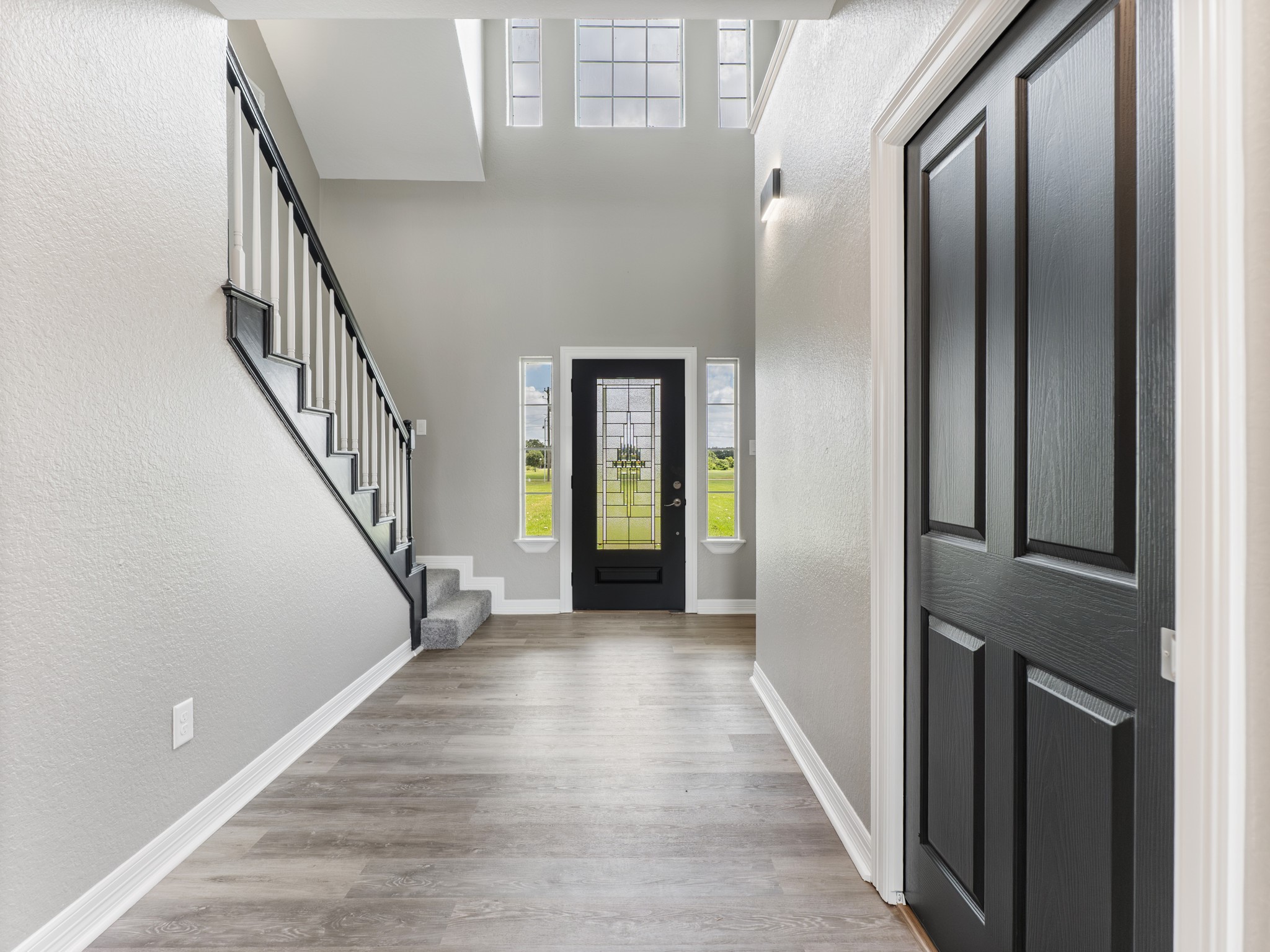 863 Bunkhouse Trail Angleton, TX 77515 - Photo 10 of 42 A glass-front entry, large entry closet and an open staircase.