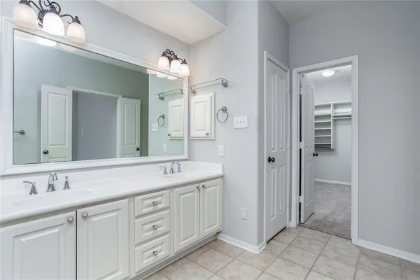 a spacious bathroom with a granite countertop sink mirror and a
