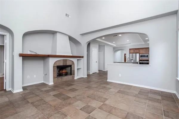 a view of a livingroom with a fireplace and cabinet